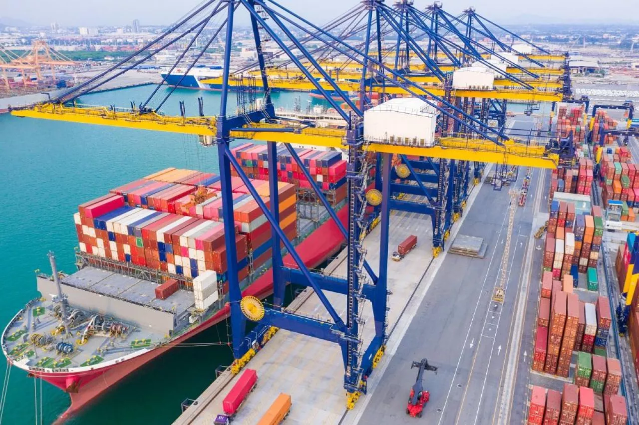 Container ships at industrial ports in the business of import, export, logistics and international maritime transport, loading of containers on cargo ships with cranes,
Transportation of goods by container trucks to customers.