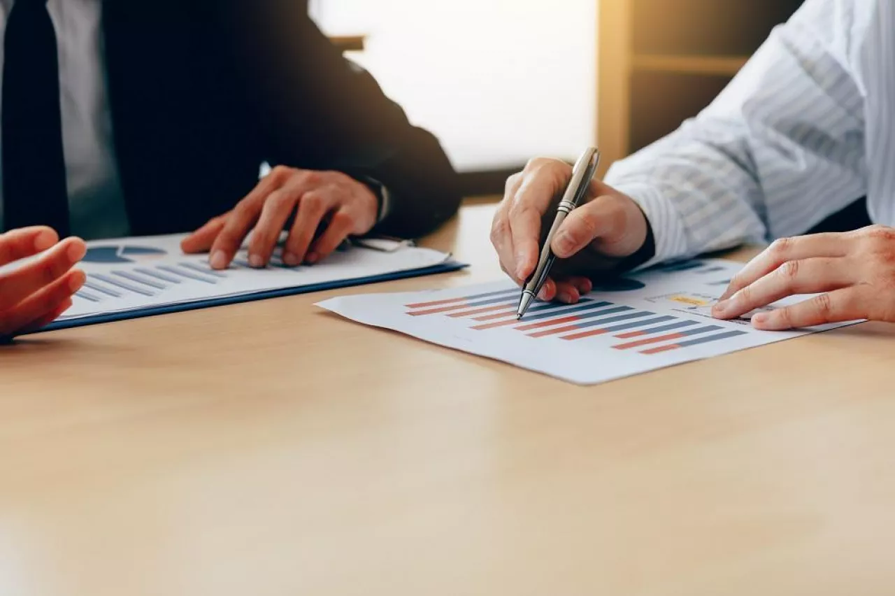 Business people talking and analysis finance cost with checking reports.