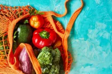 Flat lay Mesh grocery shopping eco friendly bag with vegetable and greens, Zero waste cconcept, Local farmers market, shopping mall, top view, copy space, Plastic free items.