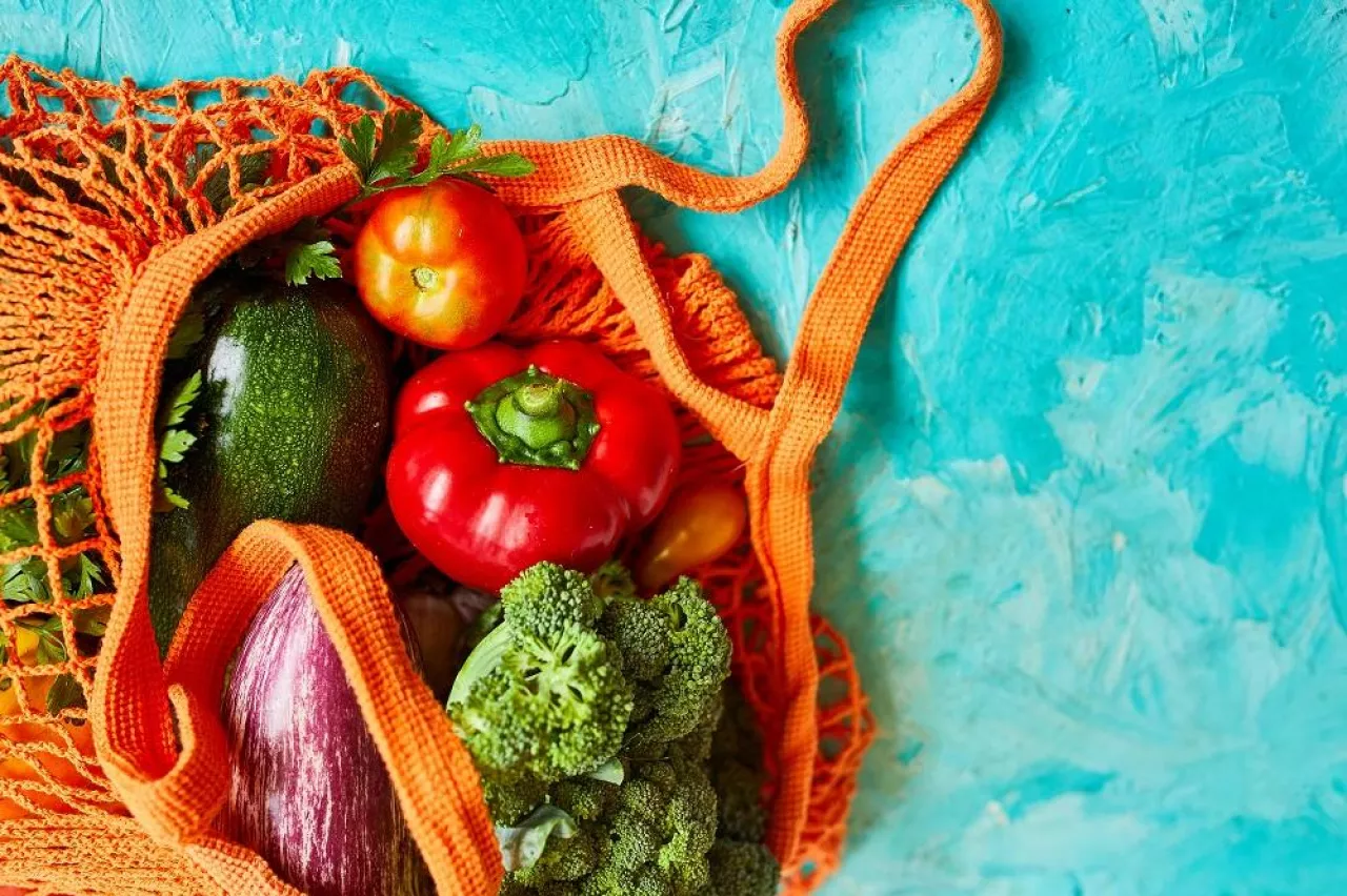 Flat lay Mesh grocery shopping eco friendly bag with vegetable and greens, Zero waste cconcept, Local farmers market, shopping mall, top view, copy space, Plastic free items.