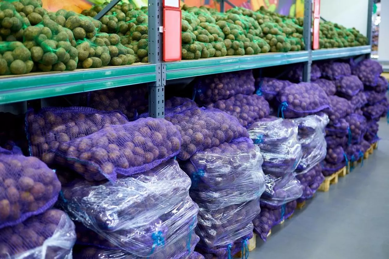 Rows of packed potatoes in a supermarket.