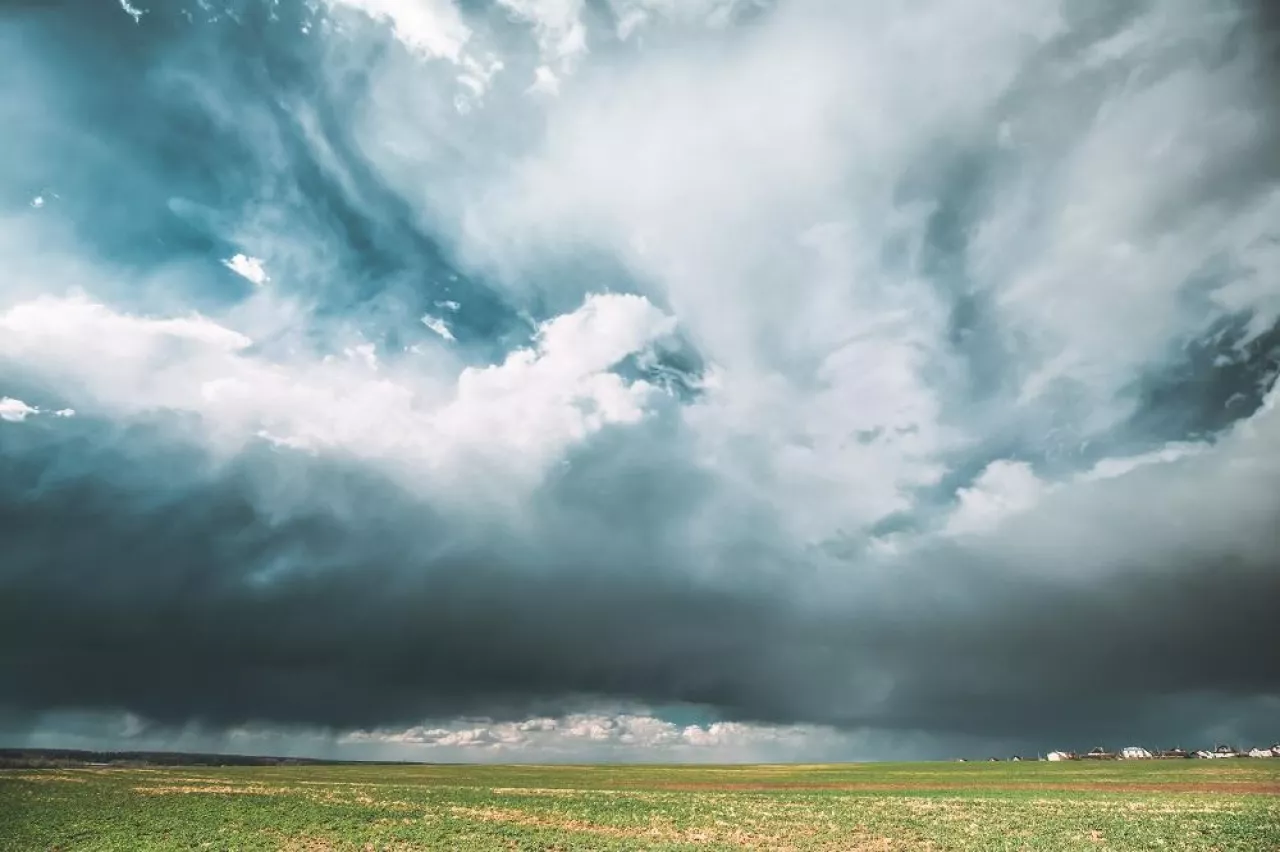Countryside Rural Field Spring Meadow During Rain. Rain Clouds On Horizon. Agricultural And Weather Forecast Concept.