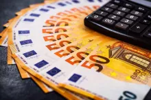 Euro Money. euro cash background. Lots of Euro money on the calculator. Euro banknotes background of Euros of Europe, EUR currency. Financial colorful background.